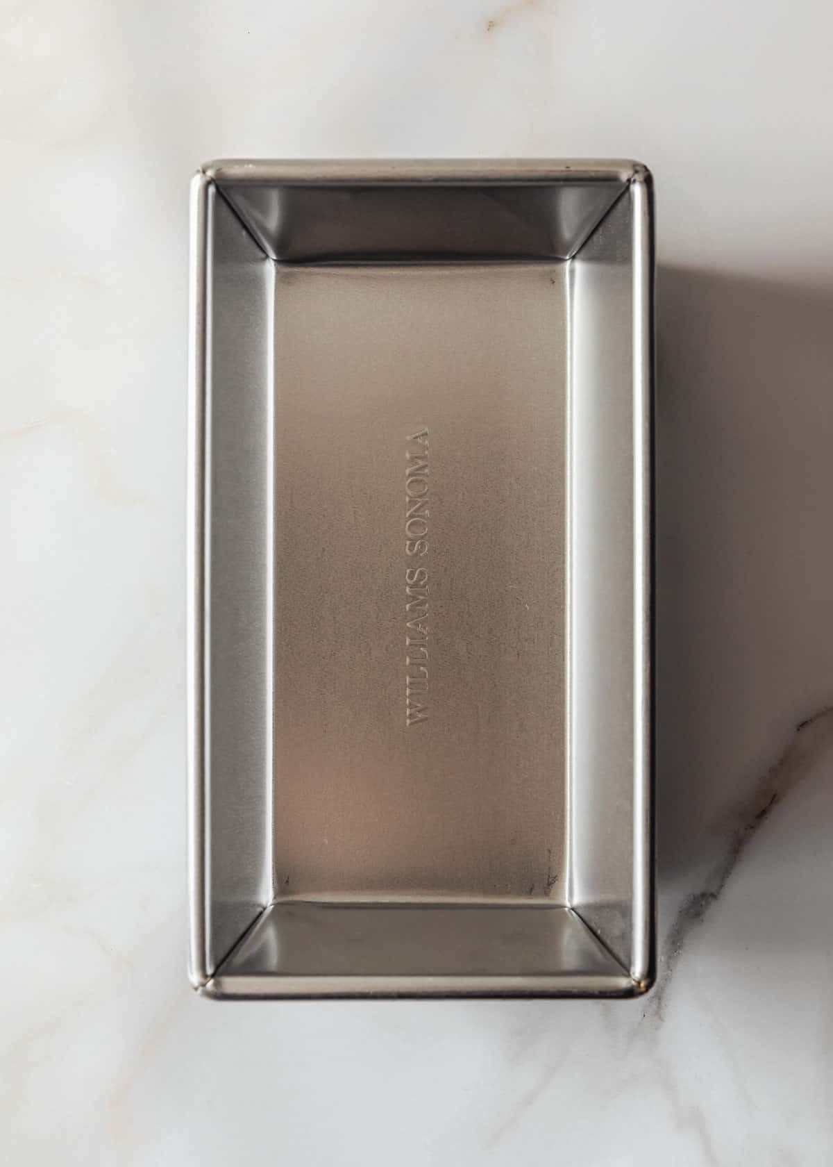 A loaf pan on a marble counter.