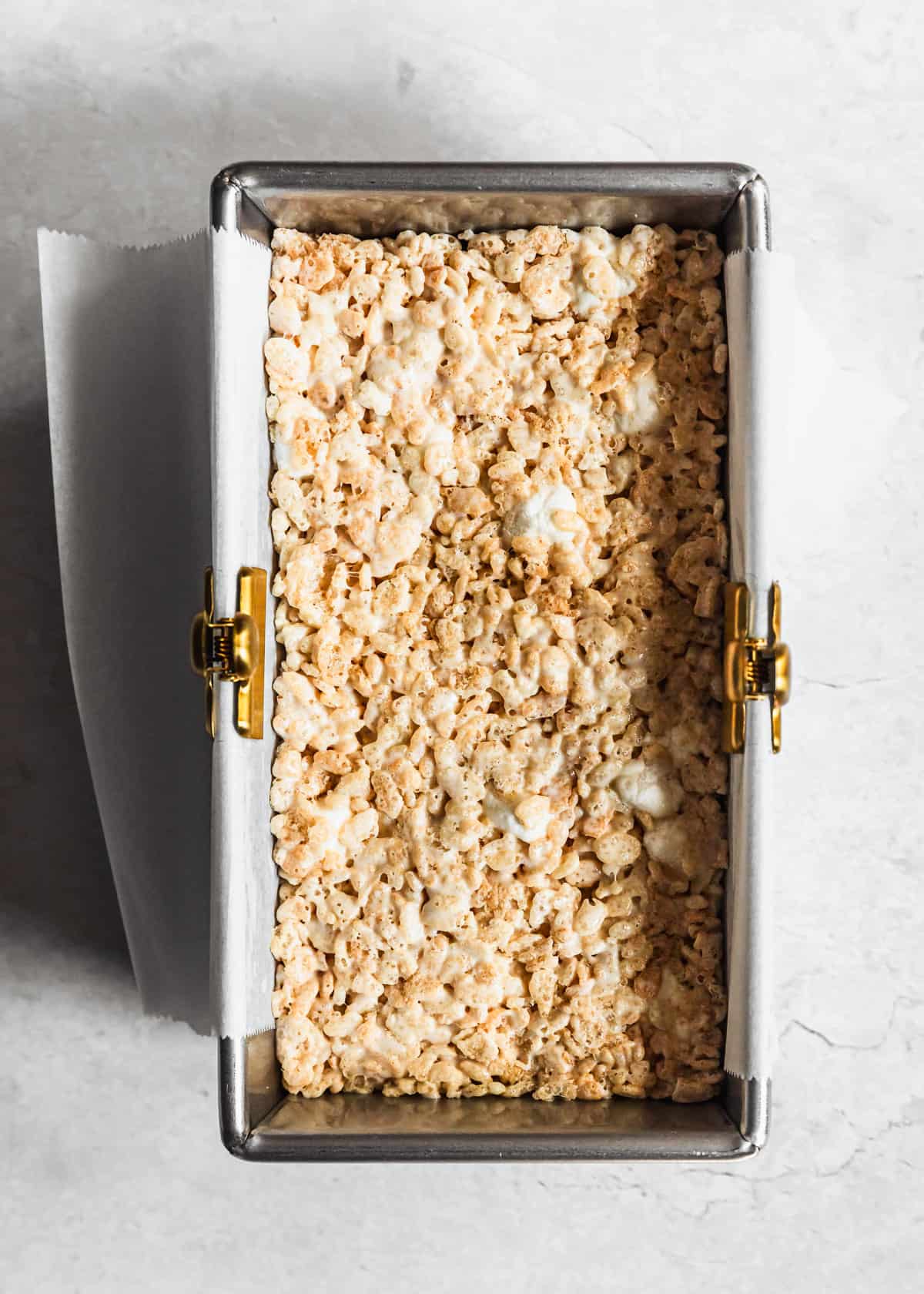 A silver pan of small batch Rice Krispies treats on a white counter.