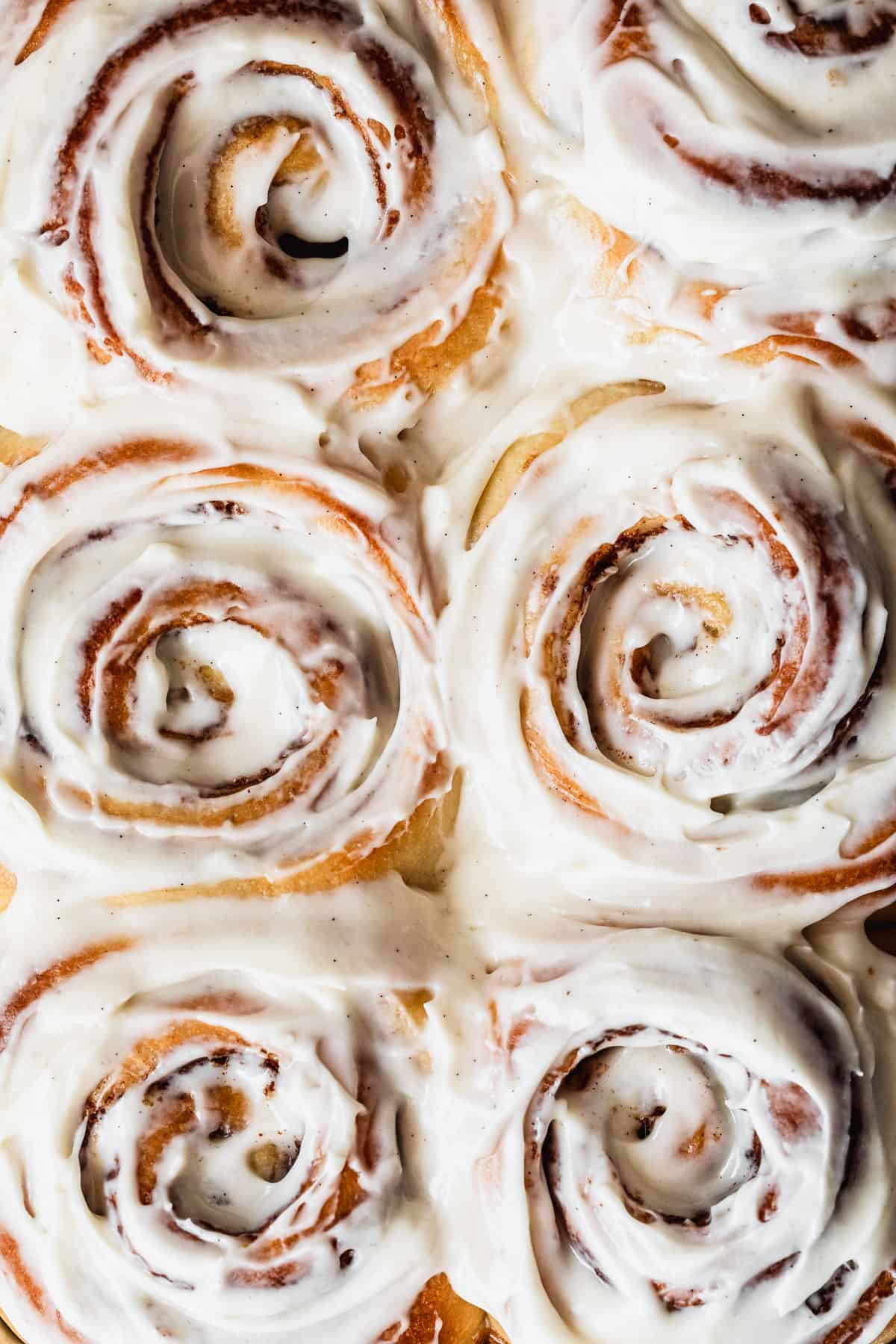 An overhead shot of small batch cinnamon rolls with cream cheese frosting.