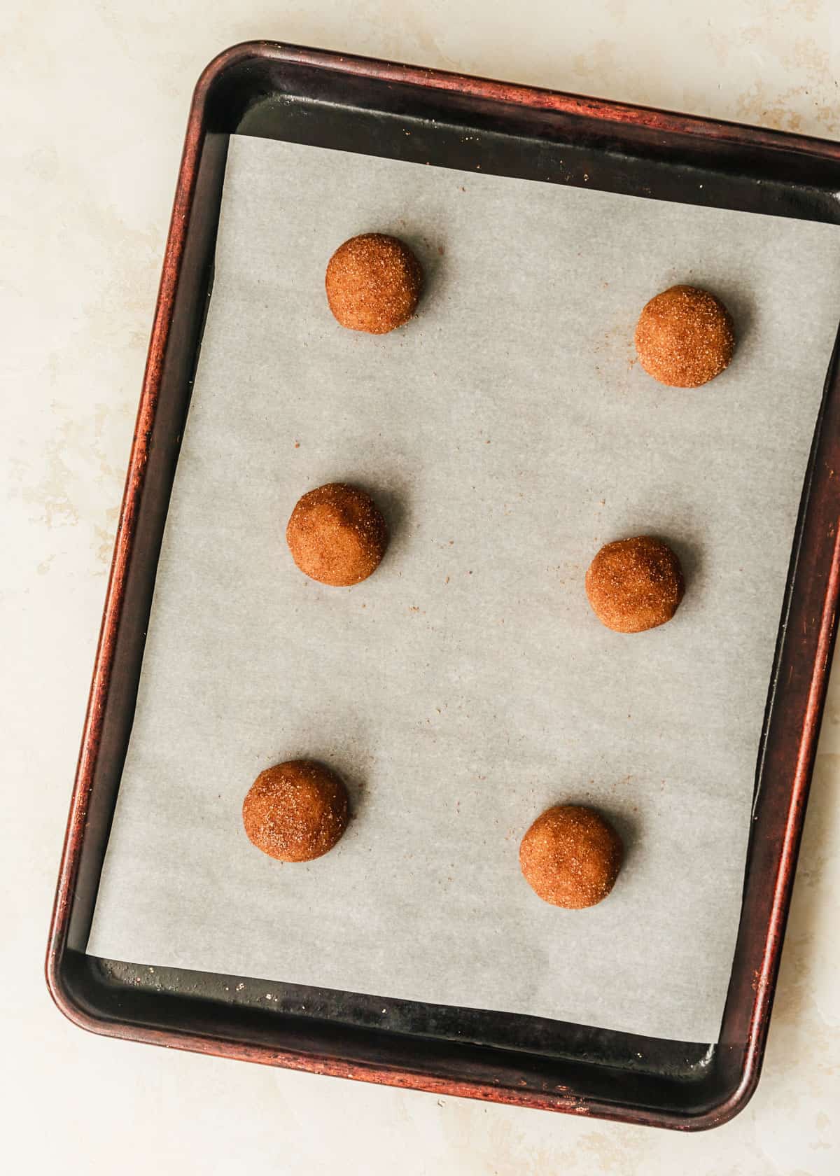 A sheet pan of raw small batch snickerdoodles.