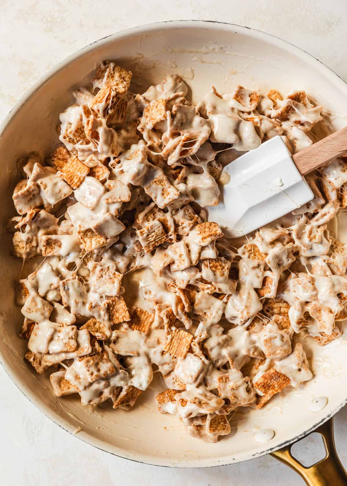 A white pan of small batch cinnamon toast crunch marshmallow treats on a tan counter.