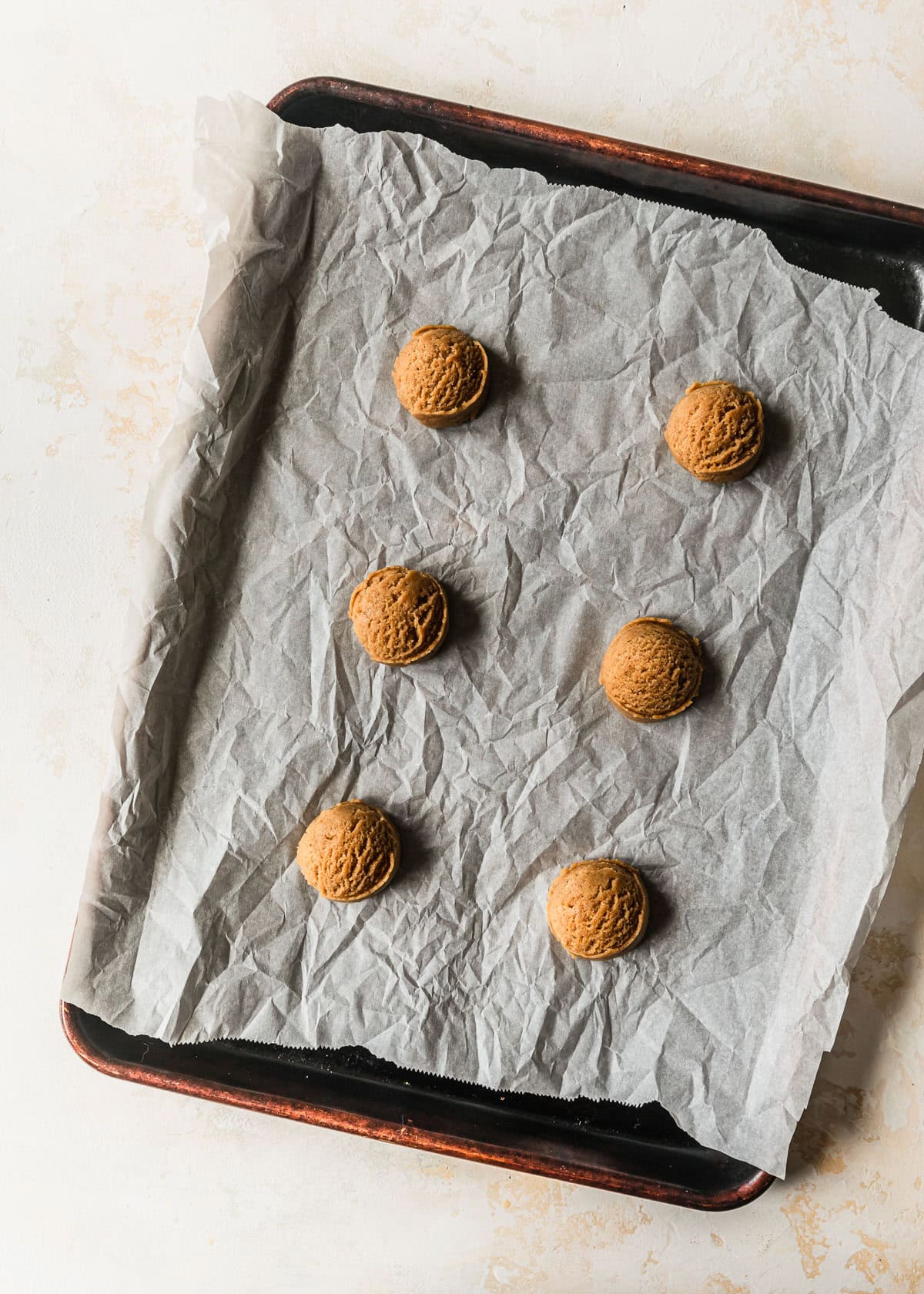 A sheet pan of raw small batch chocolate chipless cookies.