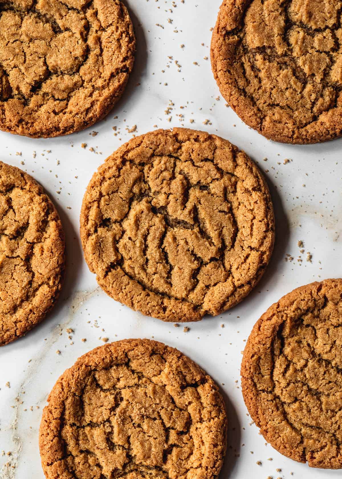 Rows of small batch chocolate chipless cookies on a white marble counter.