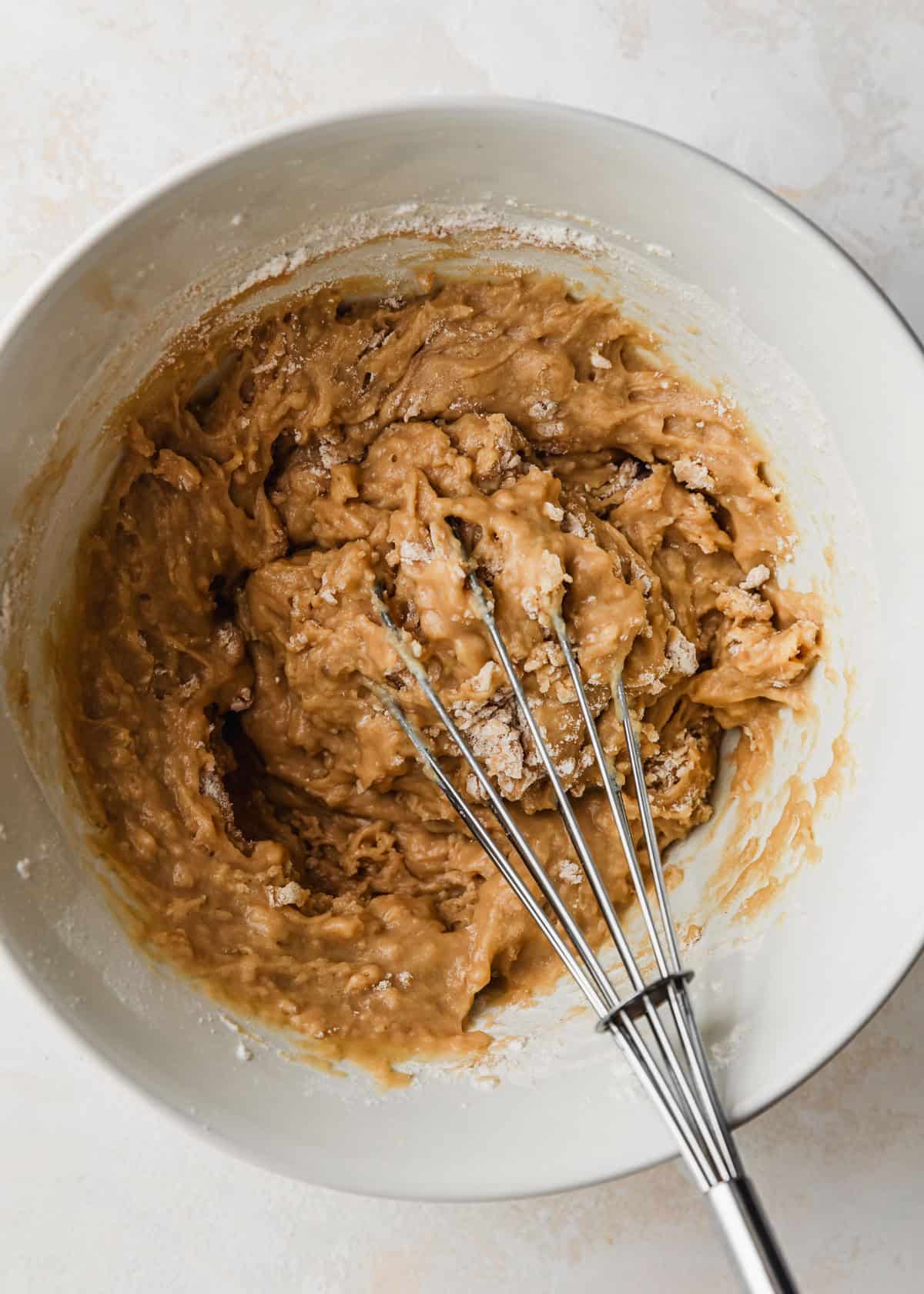A white bowl of batter for small batch chocolate chip muffins.