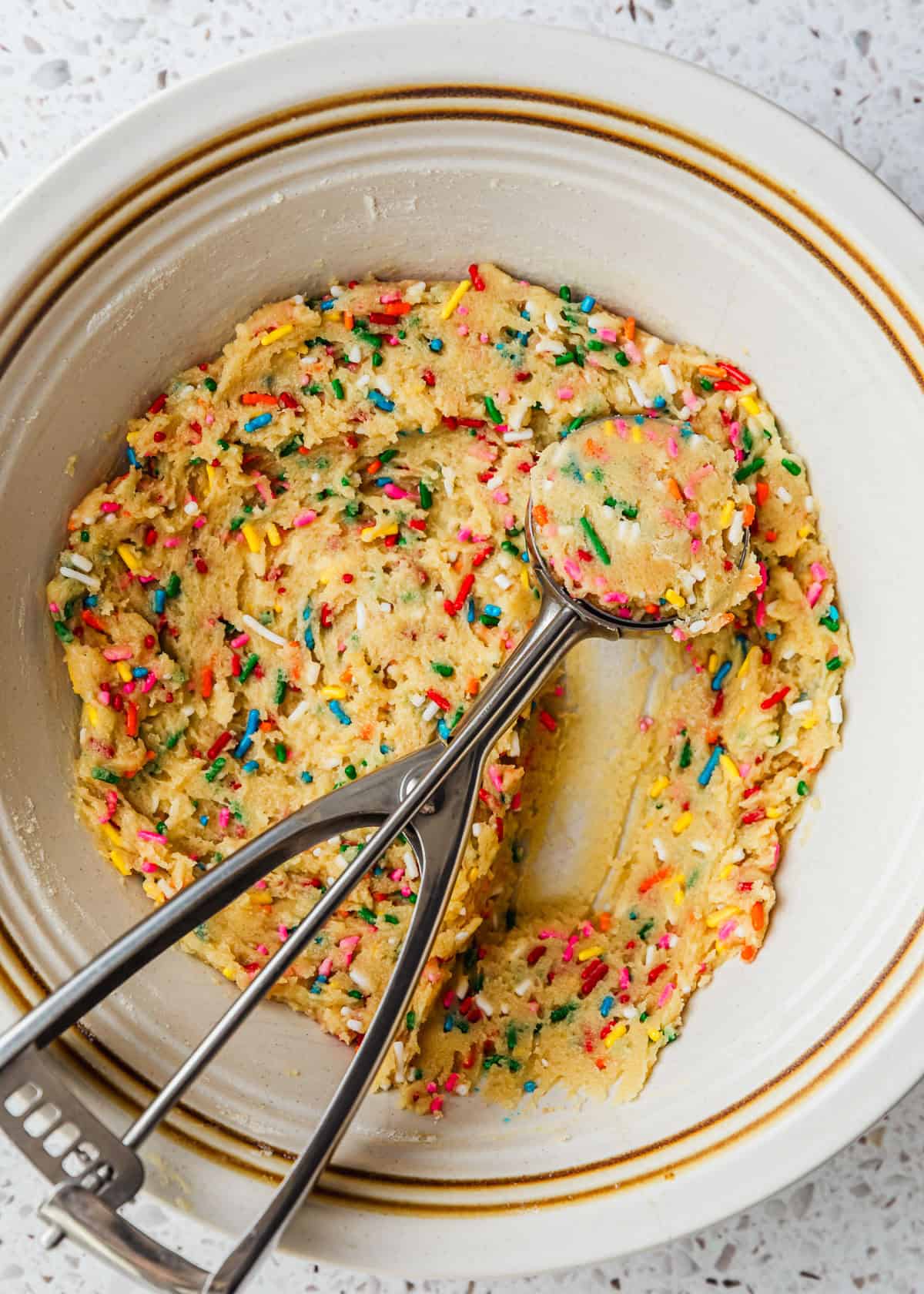 A white bowl of dough for small batch funfetti cookies.