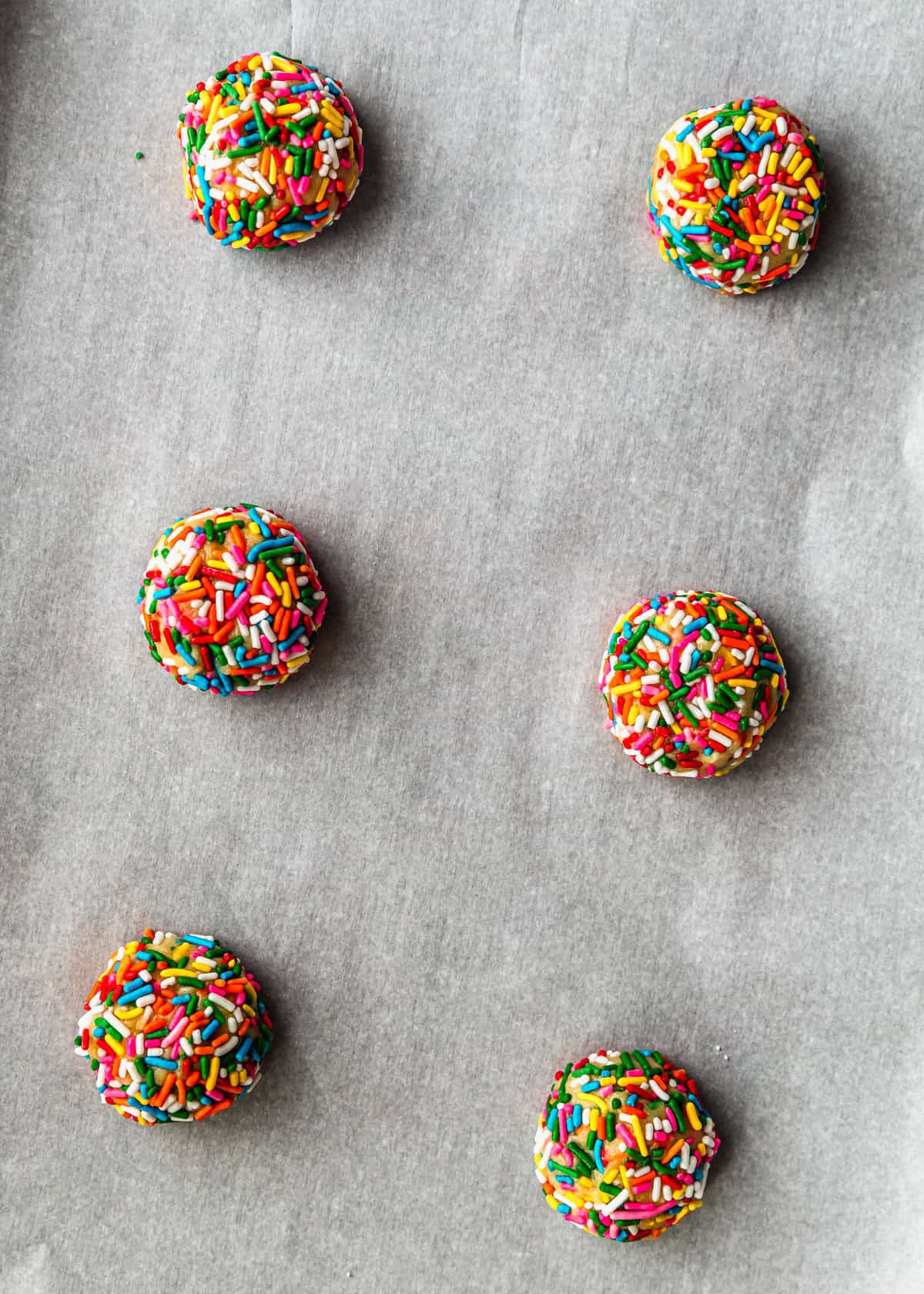 Raw small batch funfetti cookies on a sheet pan.