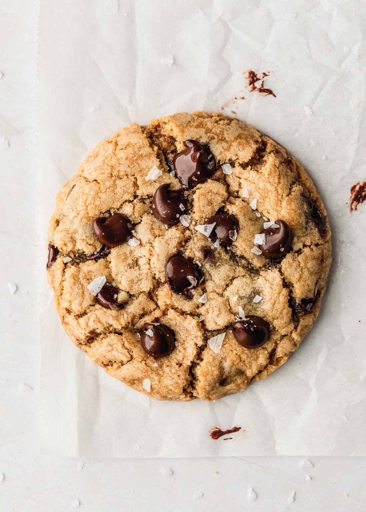 A single serve chocolate chip cookie on parchment paper.