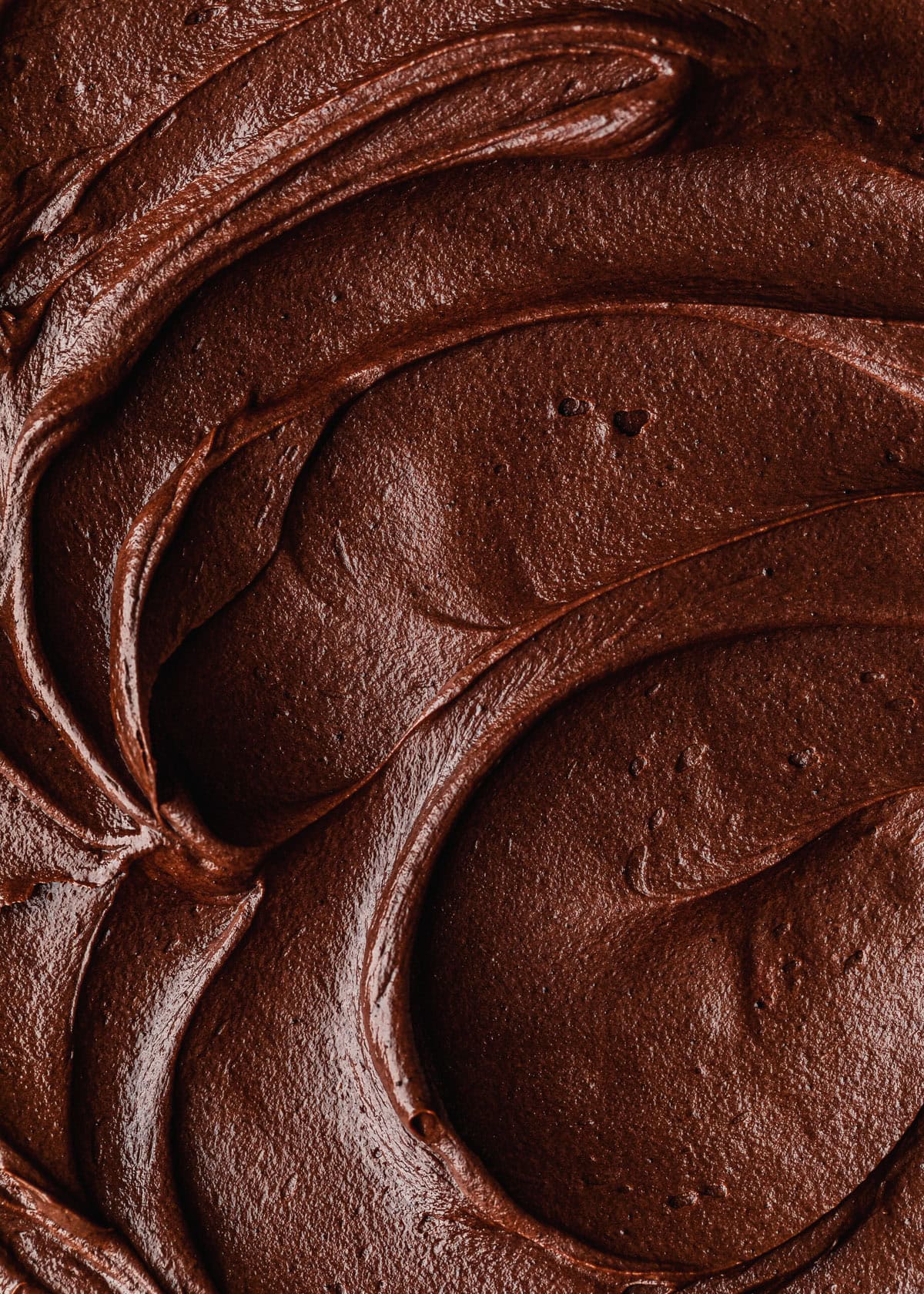Swirls of small batch chocolate buttercream frosting.