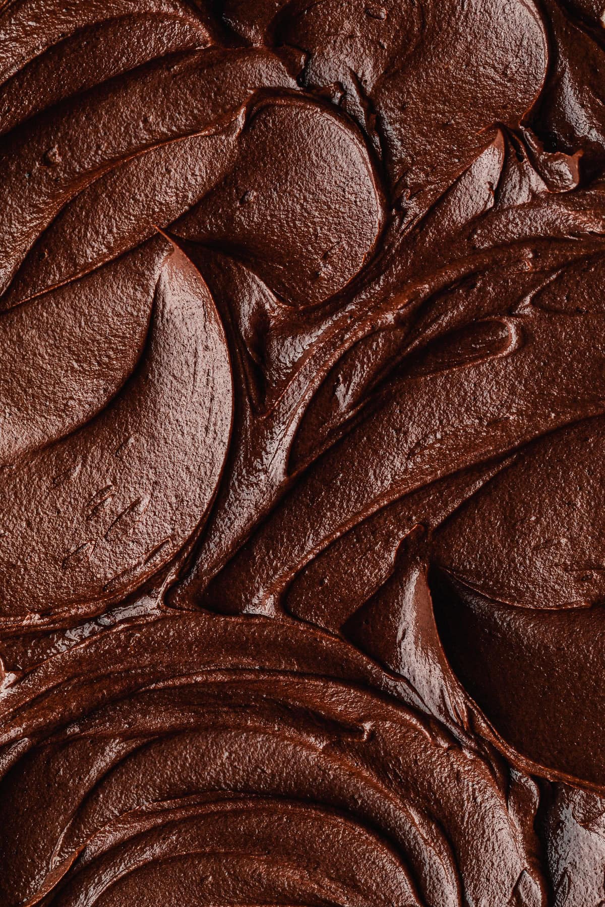 Swirls of small batch chocolate buttercream frosting.