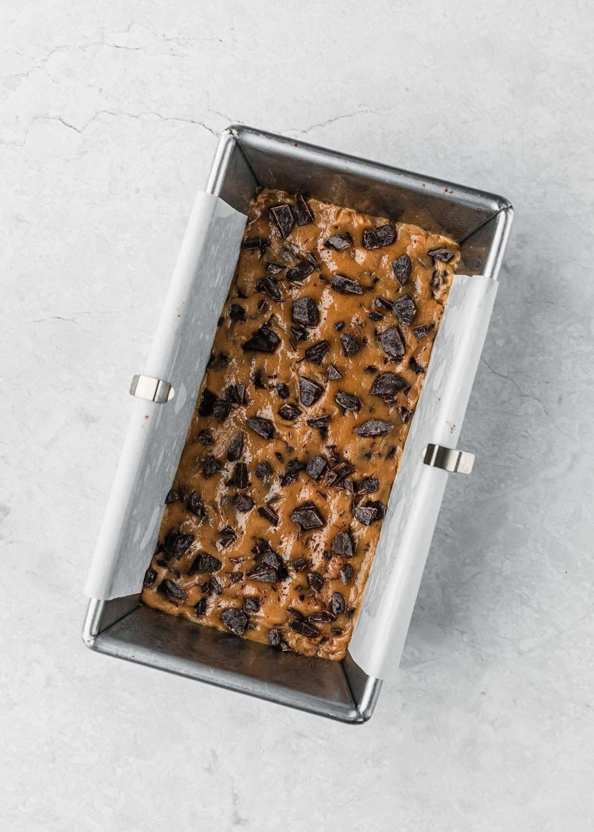 A pan of raw small batch chocolate chip cookie bars on a white counter.