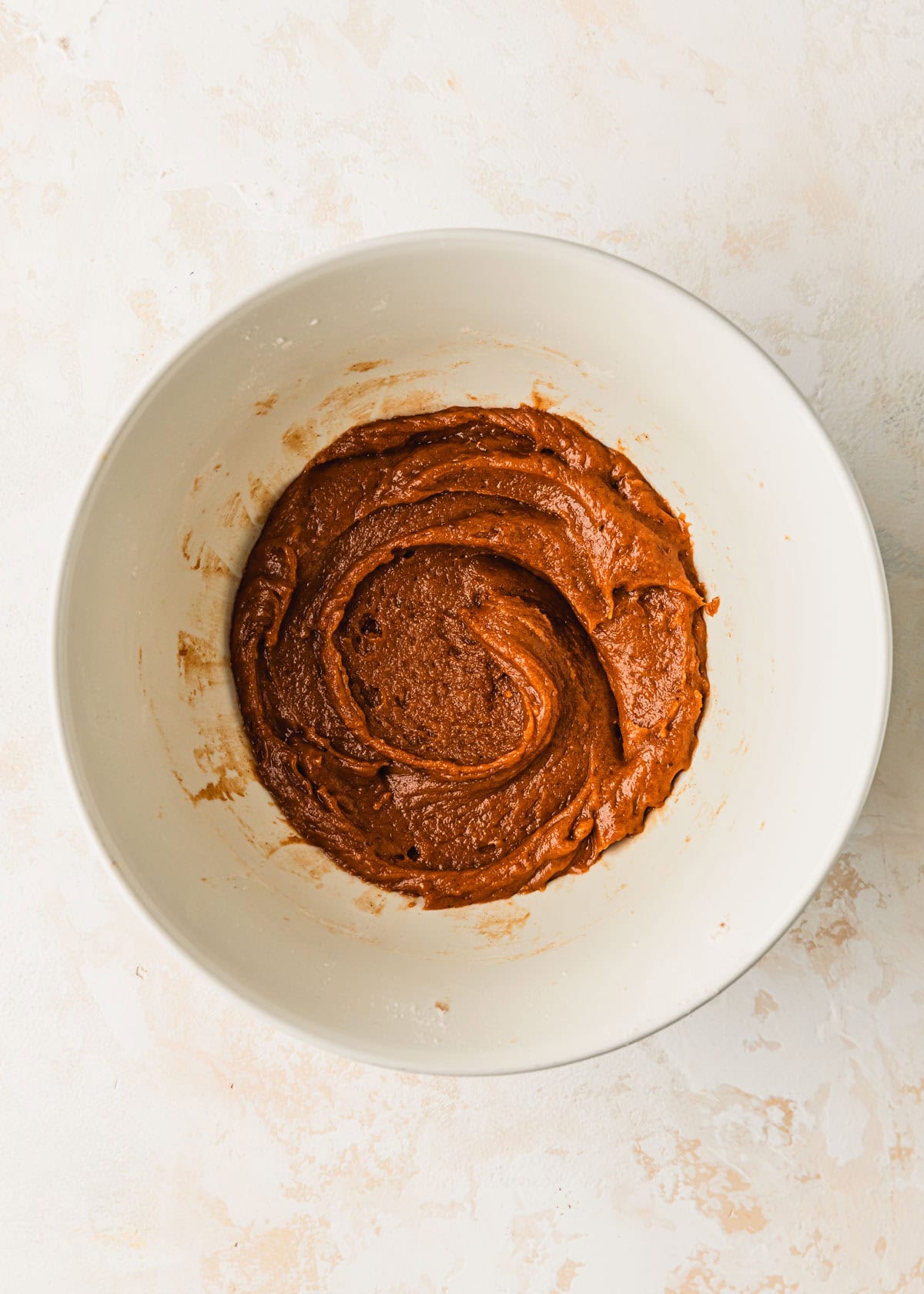 A white bowl of dough for small batch pumpkin cookies.