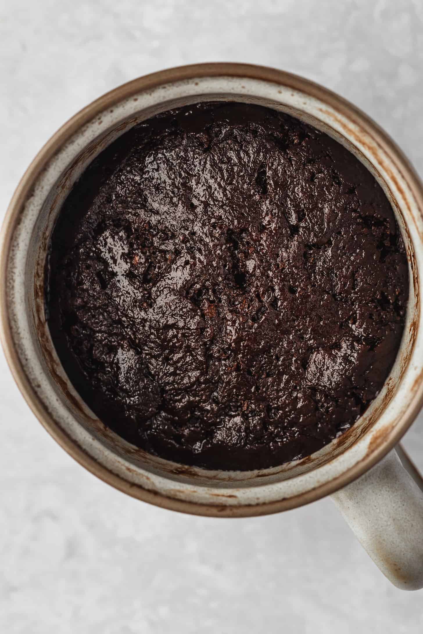 A grey mug with chocolate cake.
