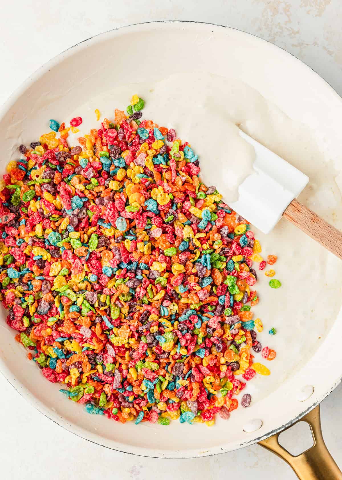 A white pan of melted marshmallows and fruit cereal.