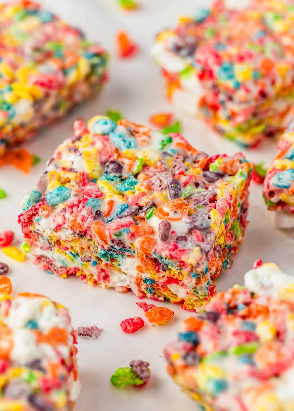 Rows of Fruity Pebbles rice crispy treats on a white counter.