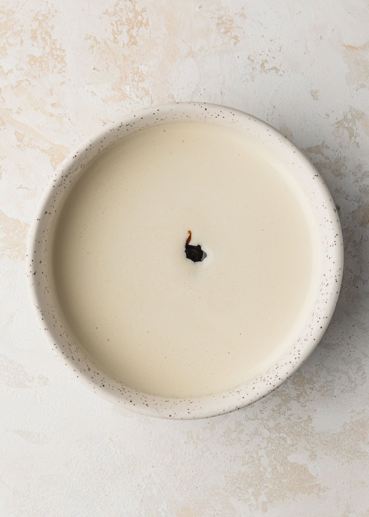 A white bowl of custard and vanilla bean paste.