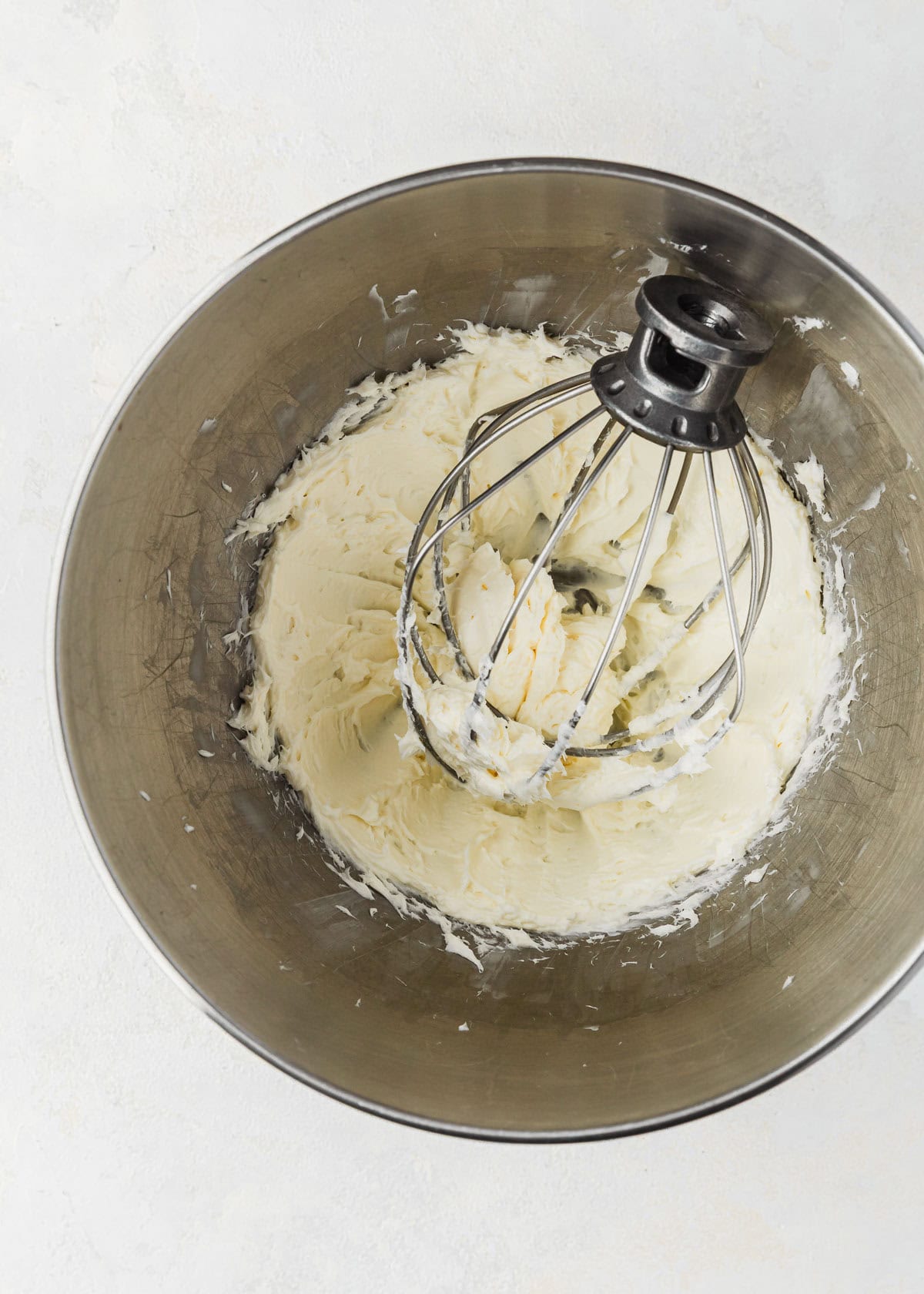 A silver bowl of whipped butter and cream cheese.