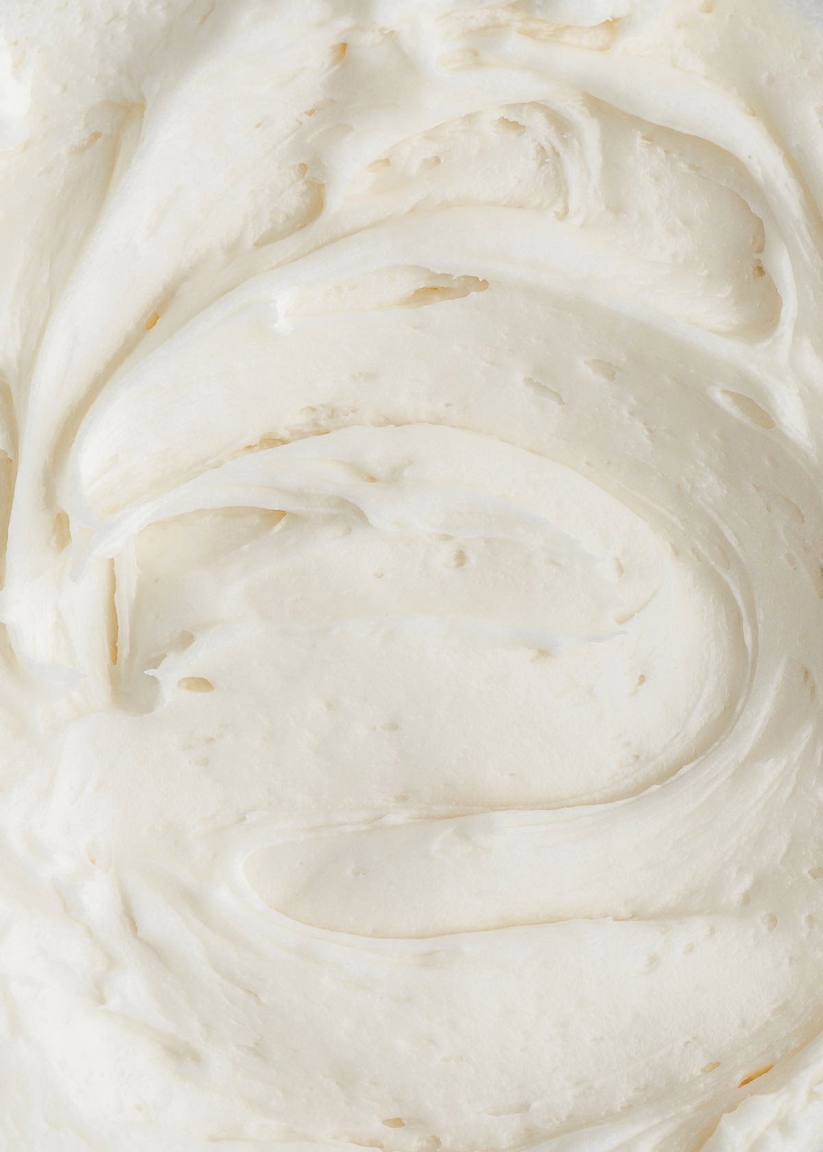 Swirls of small batch cream cheese frosting.