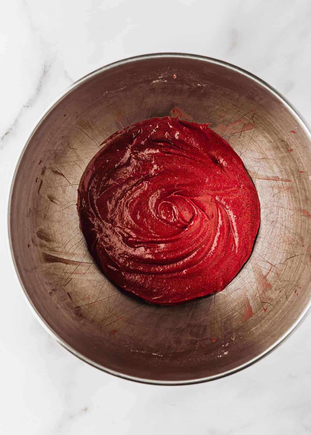 A mixing bowl of batter for small batch red velvet cupcakes.
