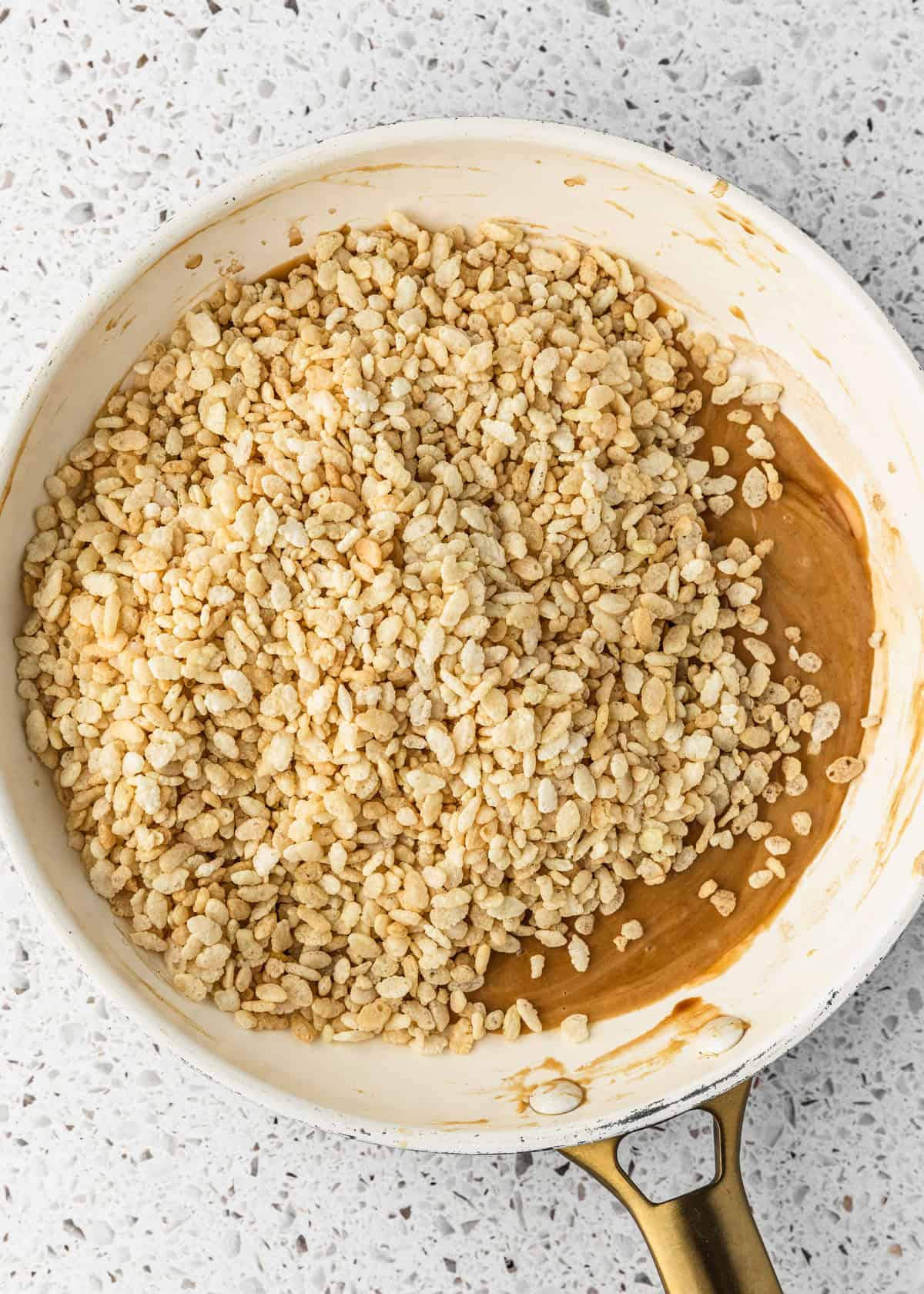 A white pan of rice cereal on a white terrazzo counter.
