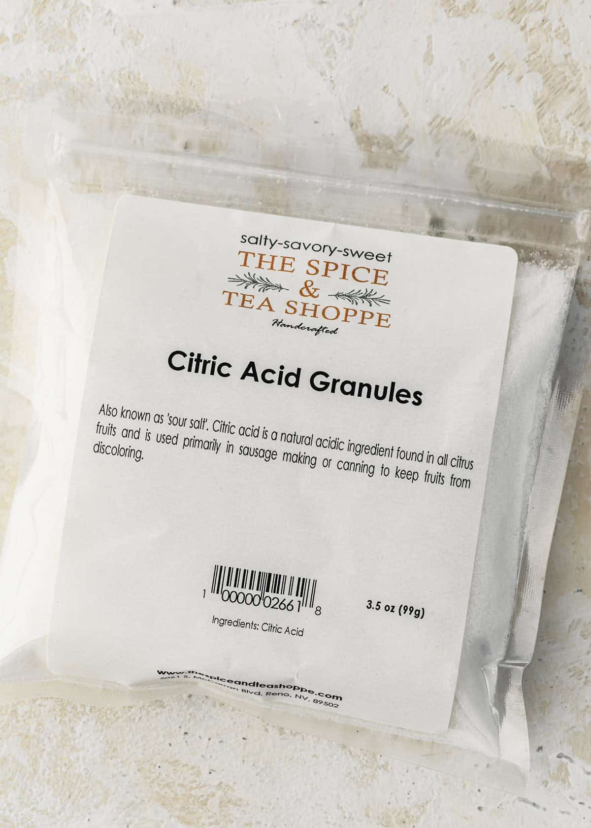 A bag of citric acid on a white counter.
