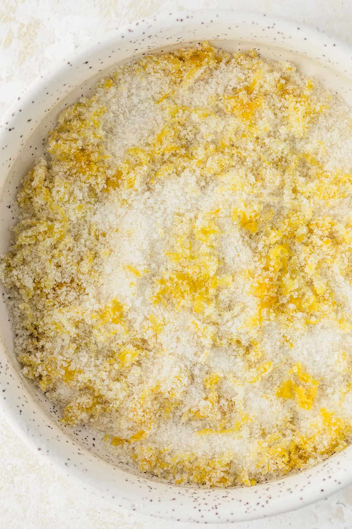 A white bowl of lemon sugar.