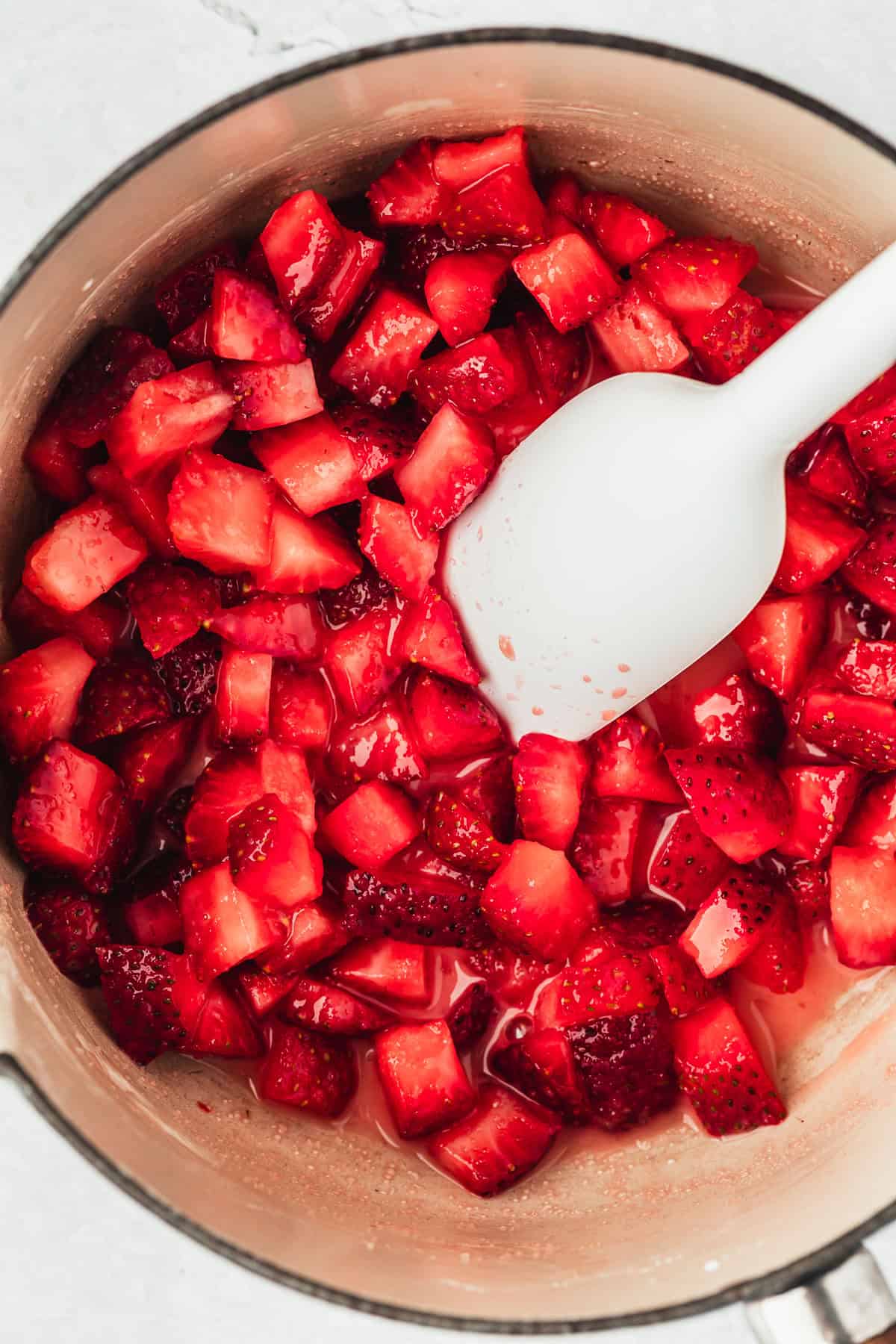 A pot of strawberries and sugar.