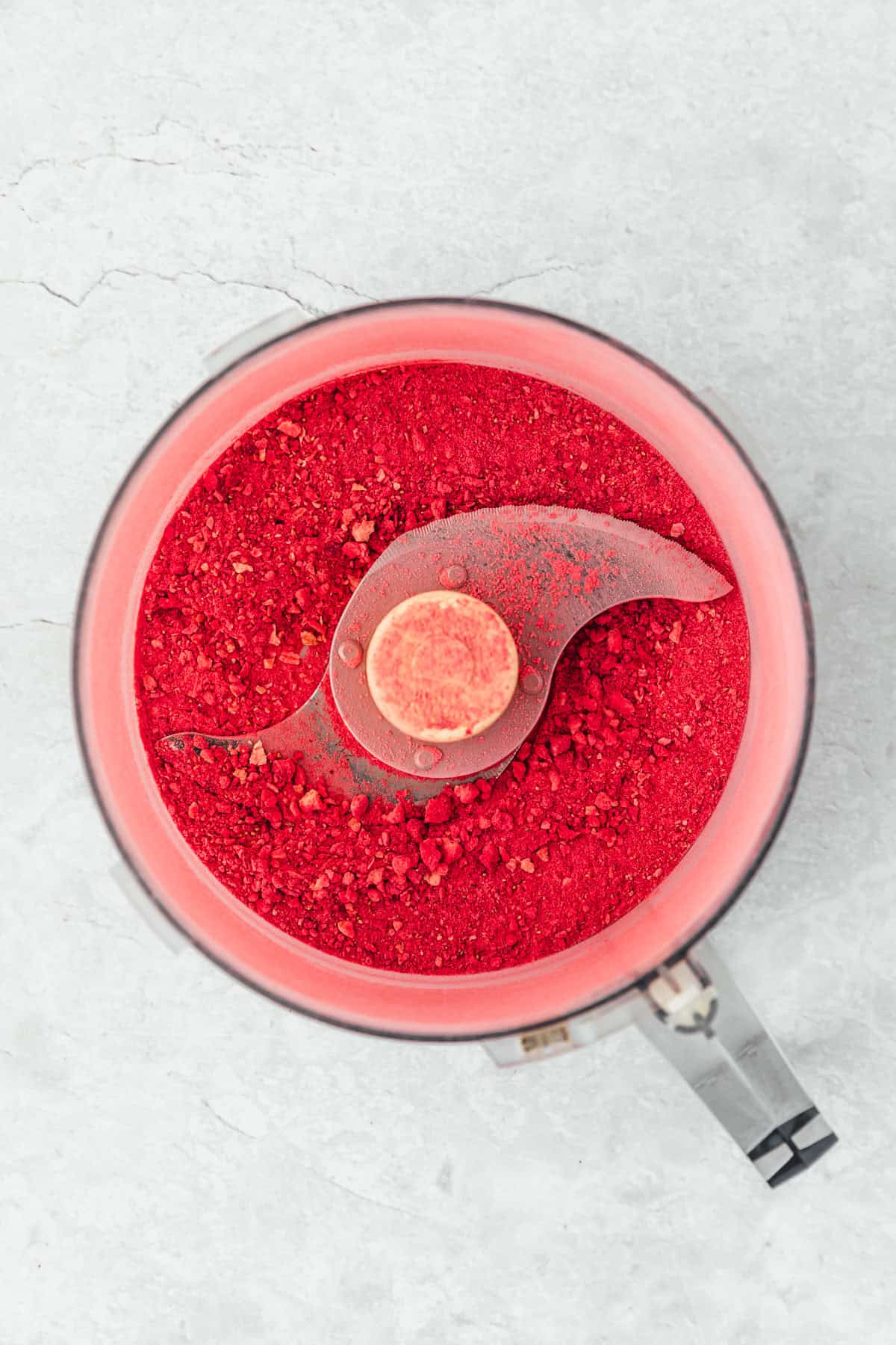 A food processor of homemade small batch strawberry powder.