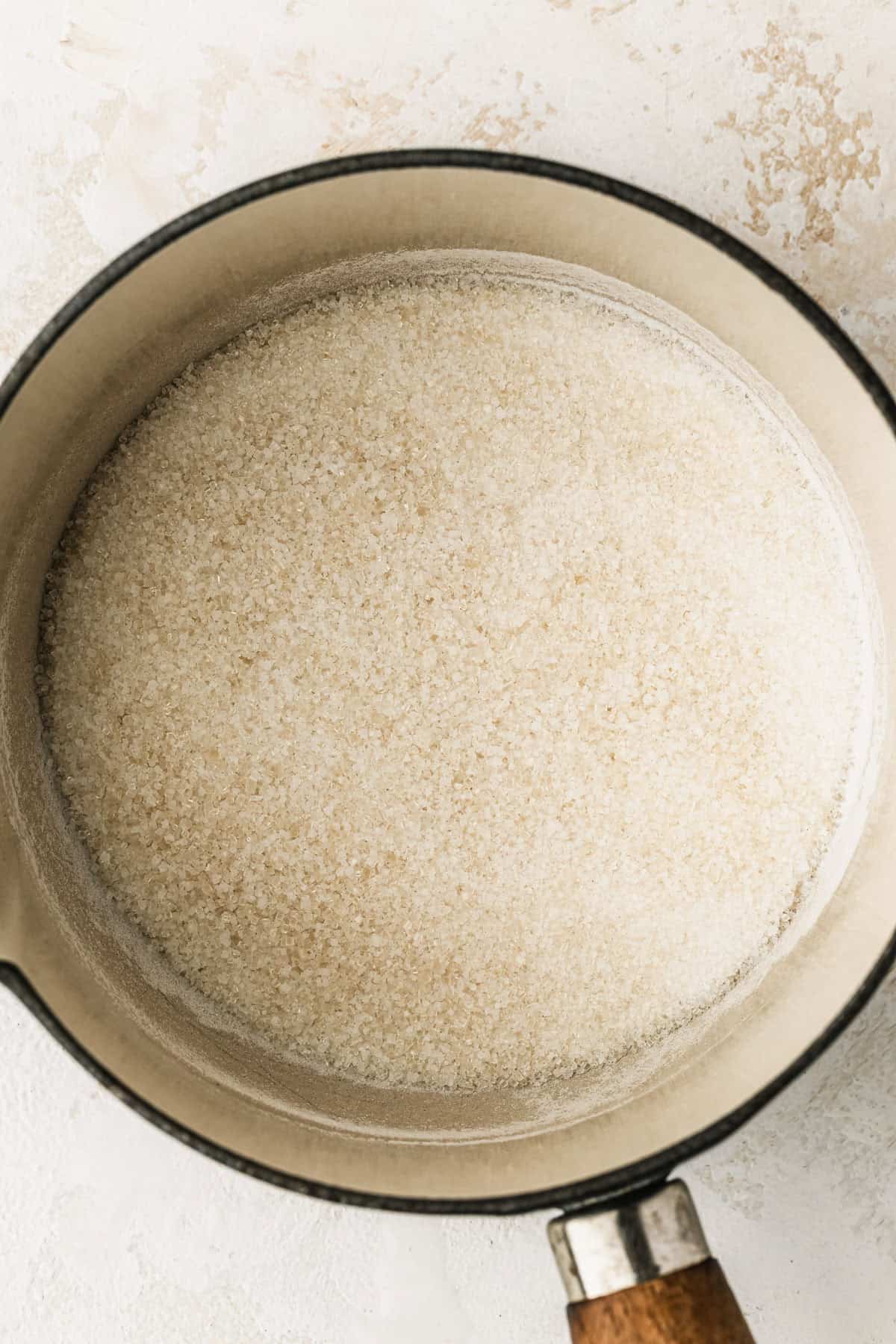 A white pot of sugar.