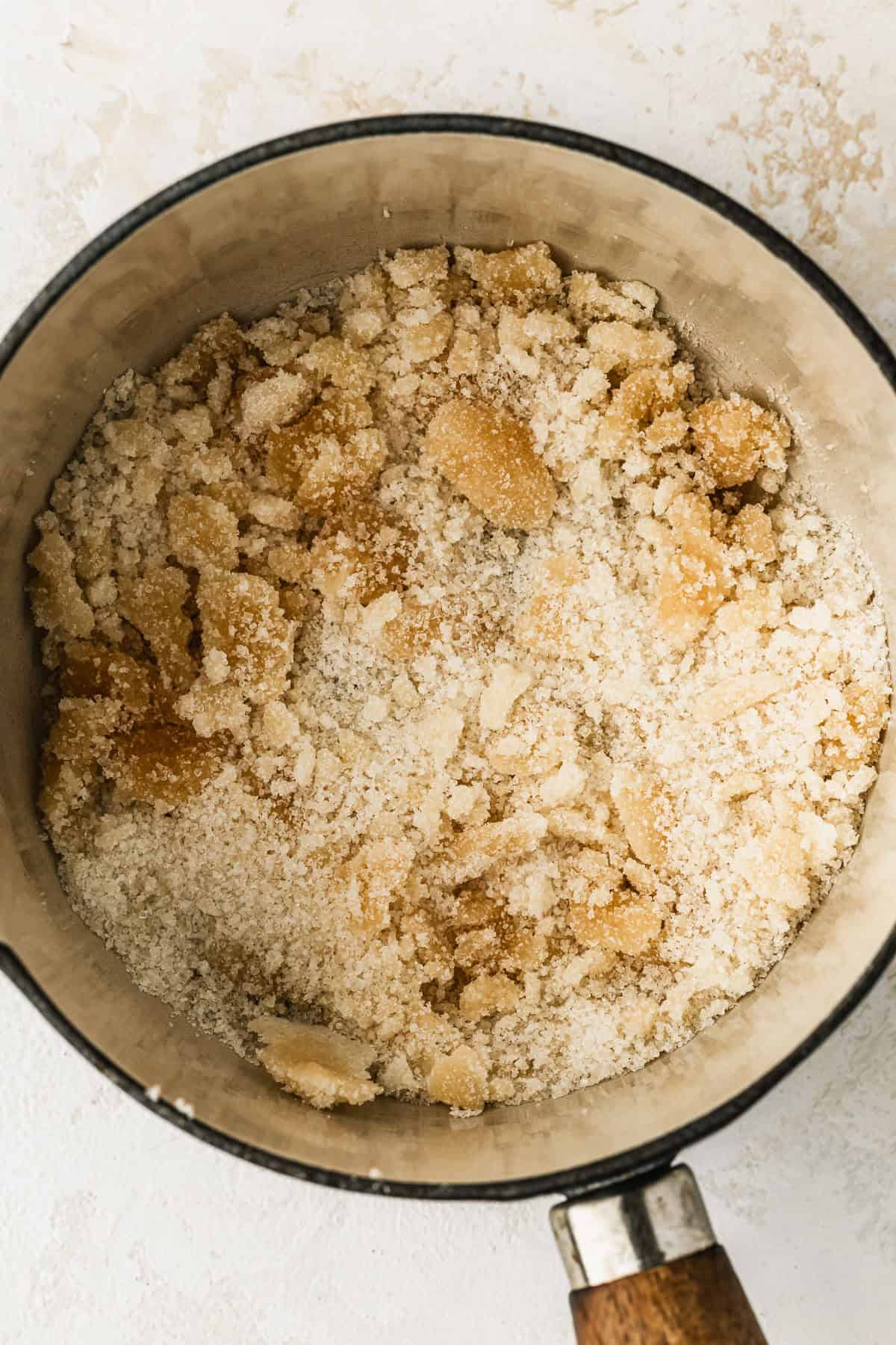 A white pot of clumped sugar.