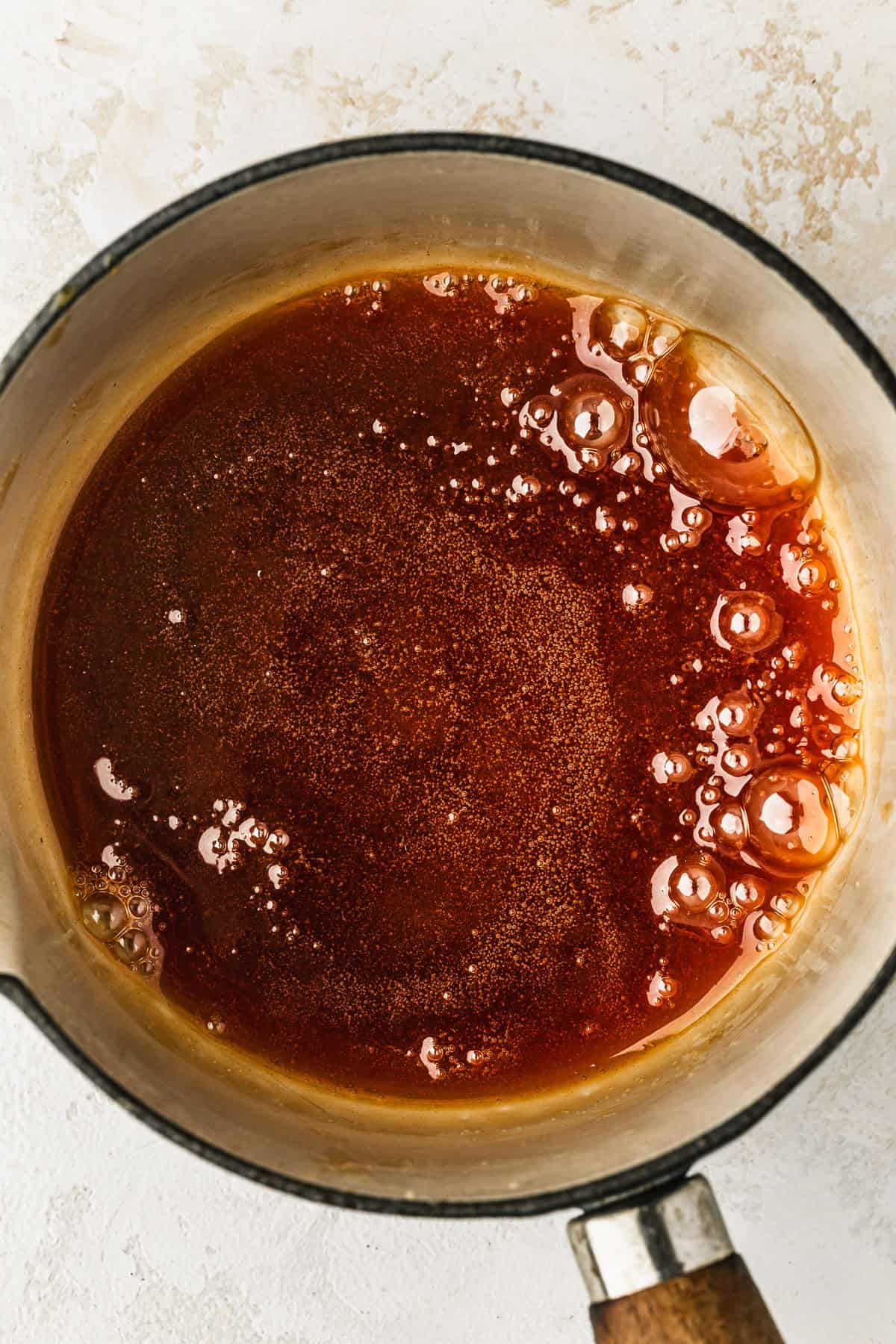 A white pot of melted caramelized sugar.