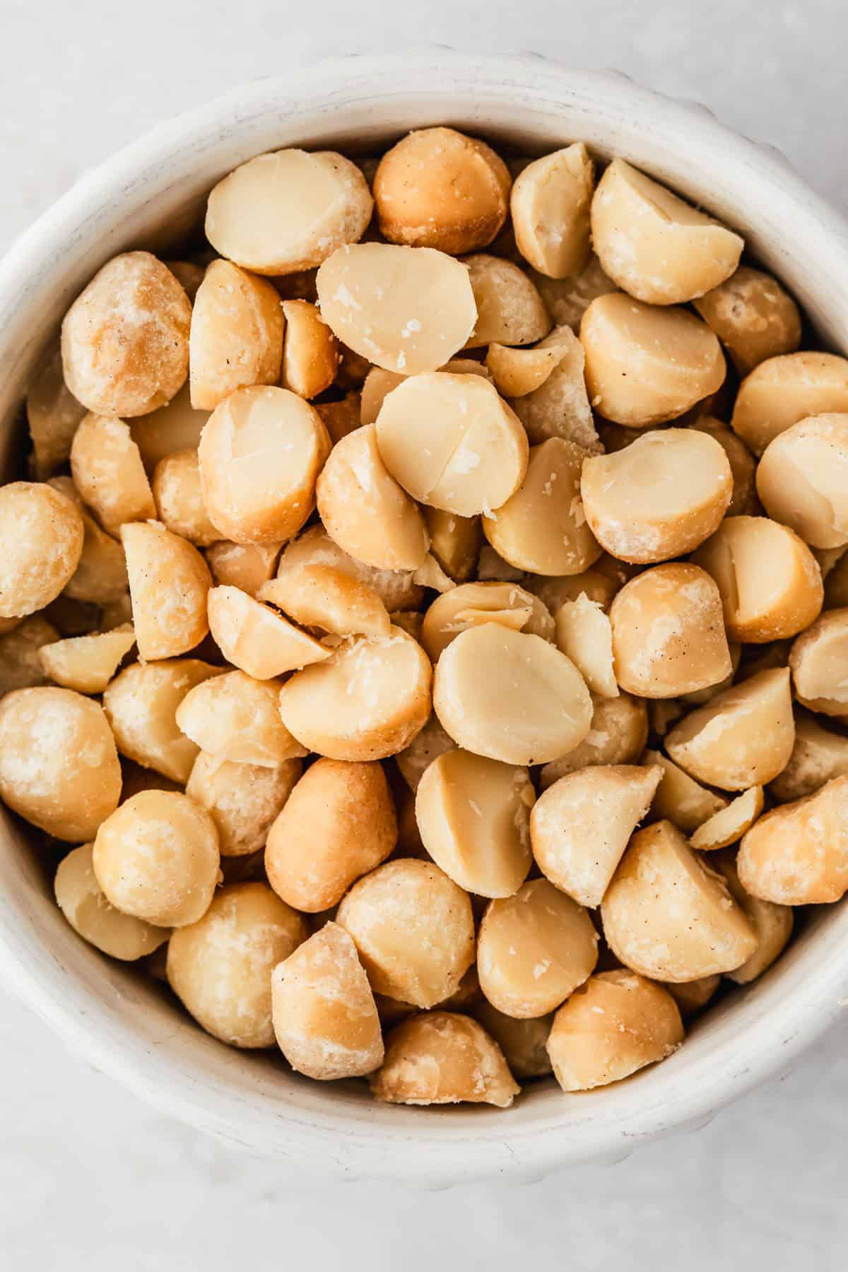 A white bowl of macadamia nuts.