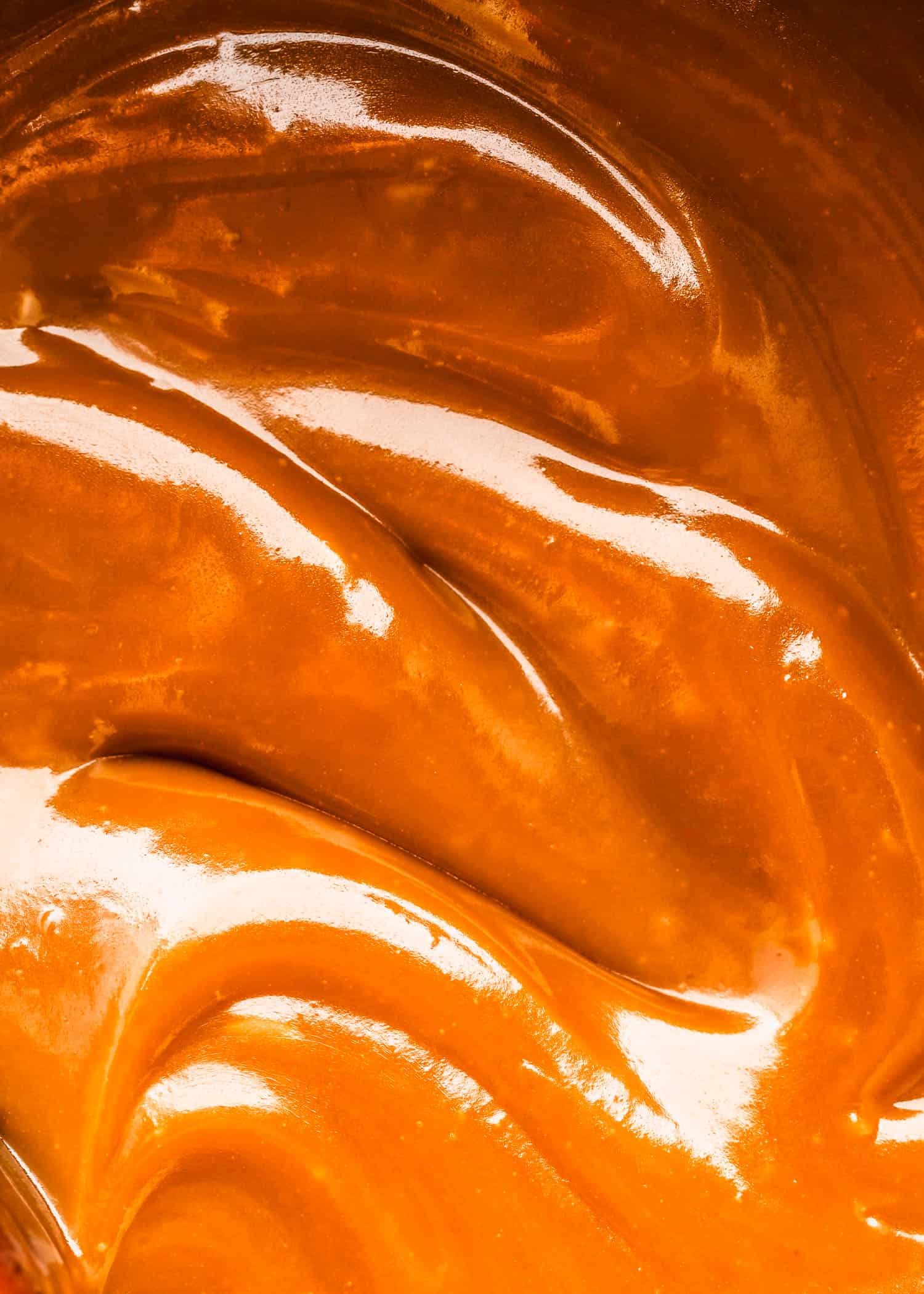 Swirls of small batch homemade butterscotch sauce.