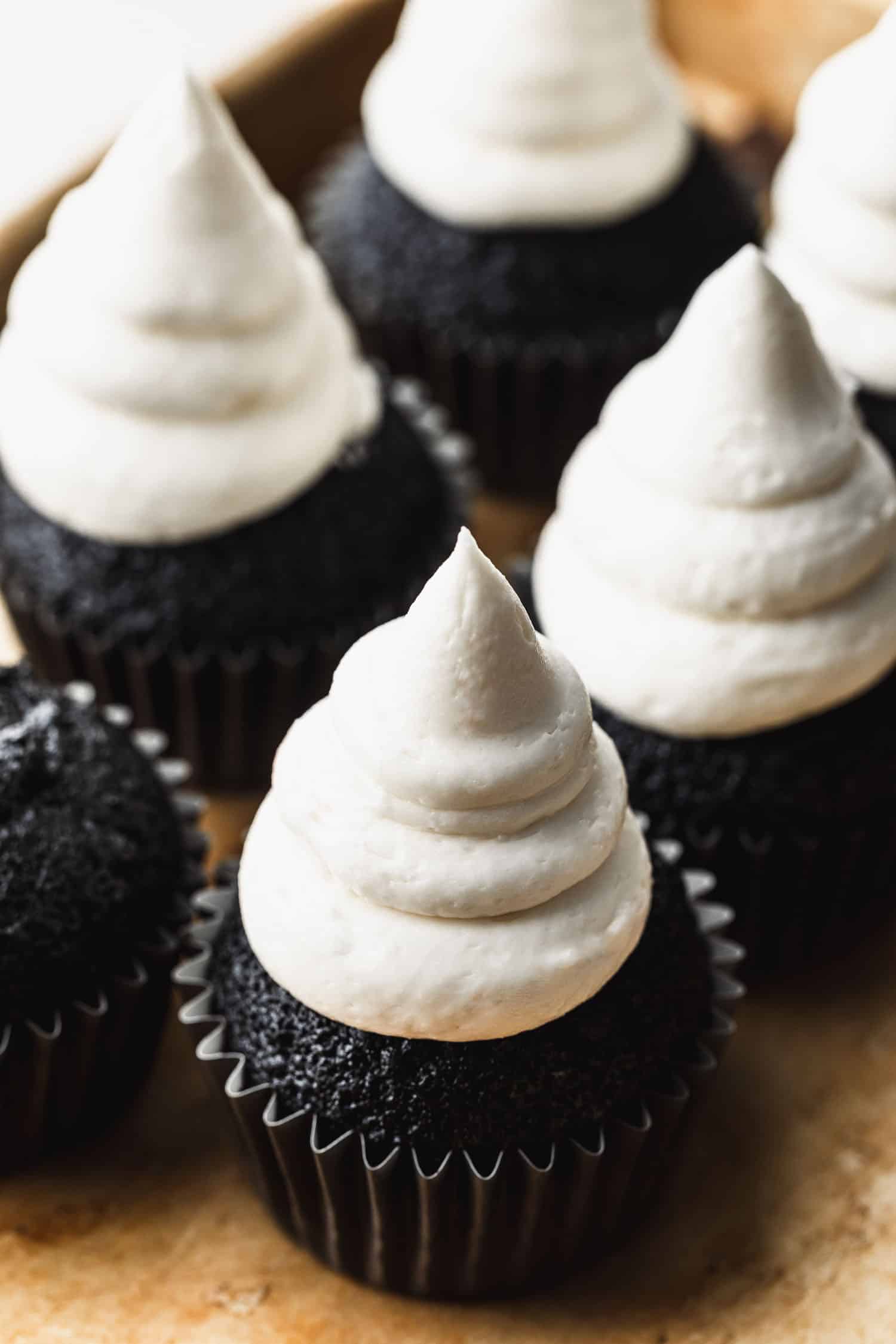 Small batch ghost cupcakes on a gold pan.