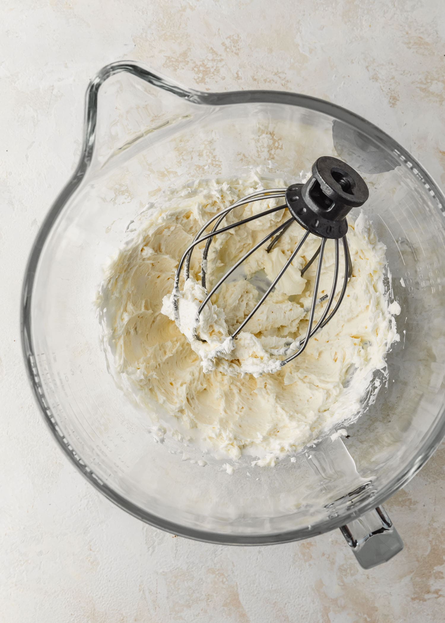 A clear bowl of mixed butter and marshmallow fluff.