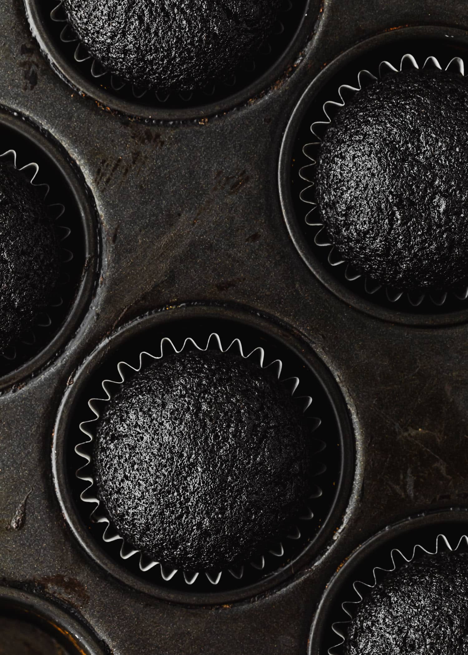 A pan of chocolate cupcakes for small batch ghost cupcakes.