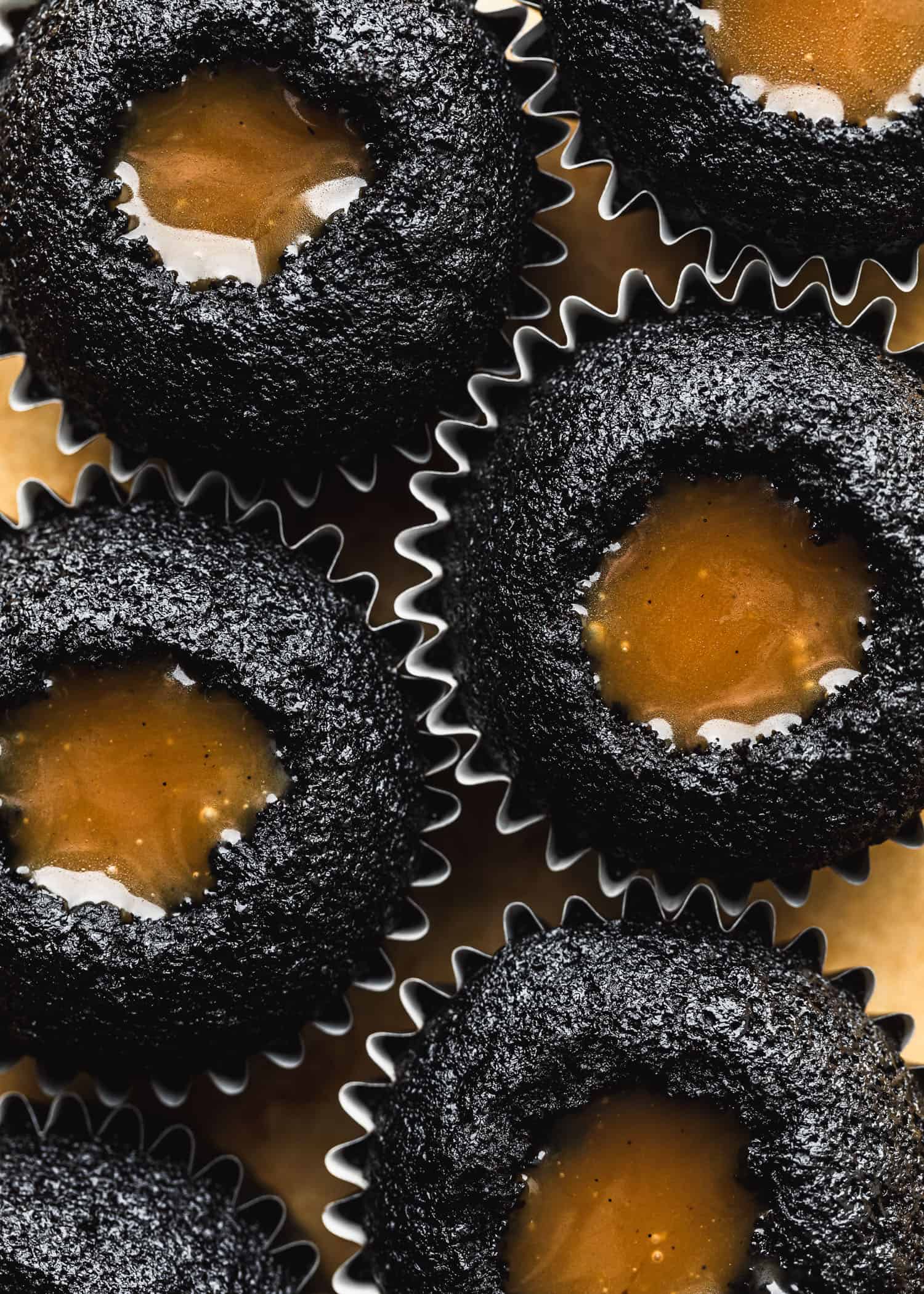 A pan of chocolate cupcakes filled with butterscotch for small batch ghost cupcakes.
