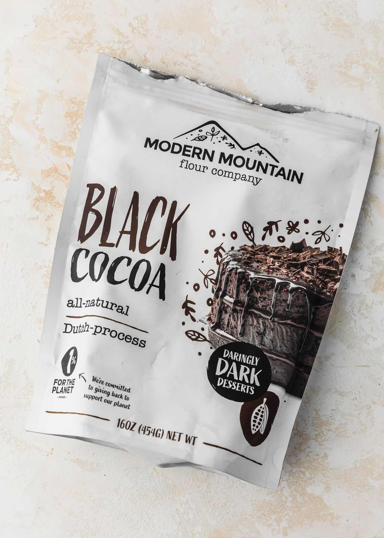 A package of black cocoa powder on a tan counter.