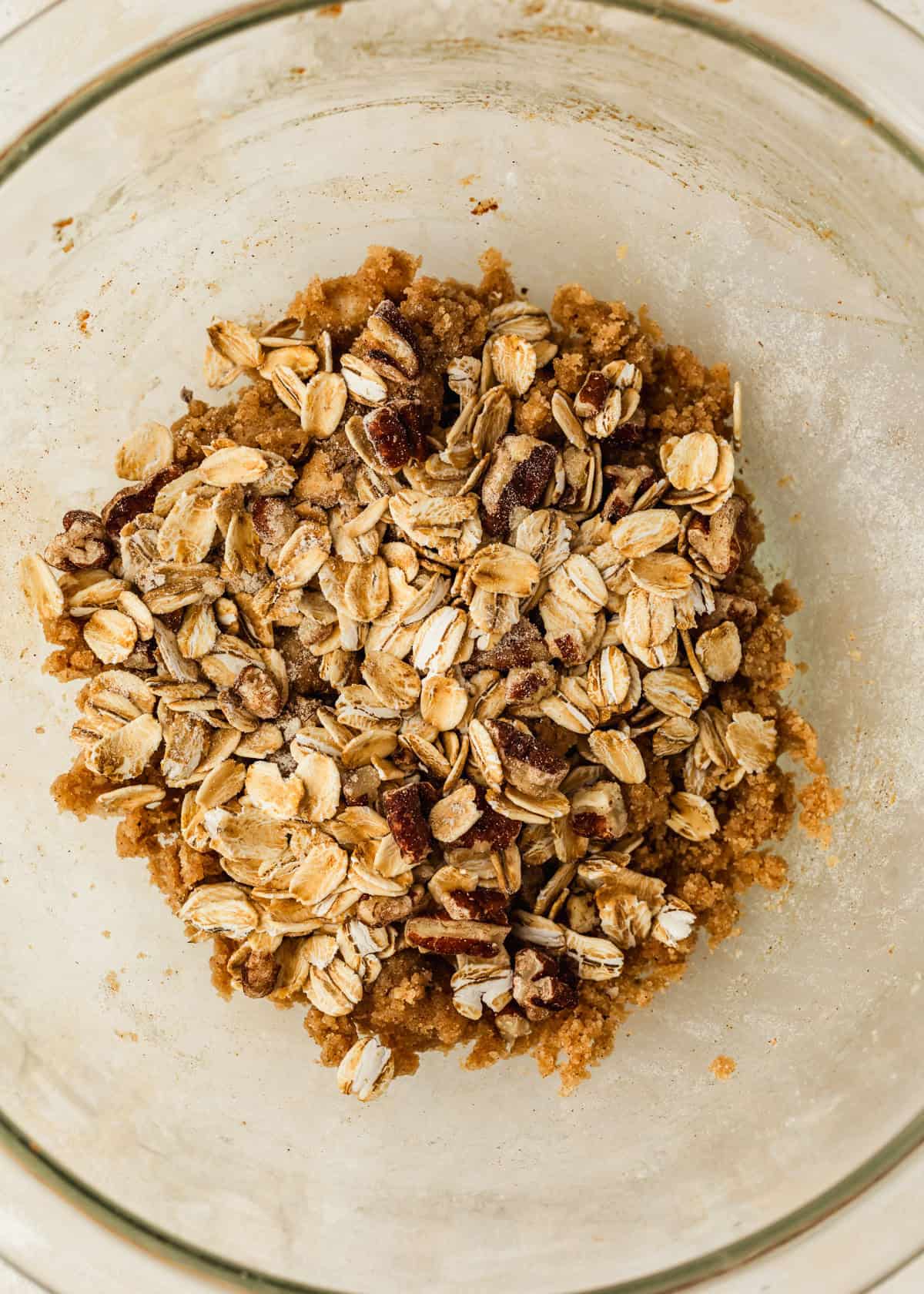 A clear bowl of oat topping for a single-serving apple crisp.
